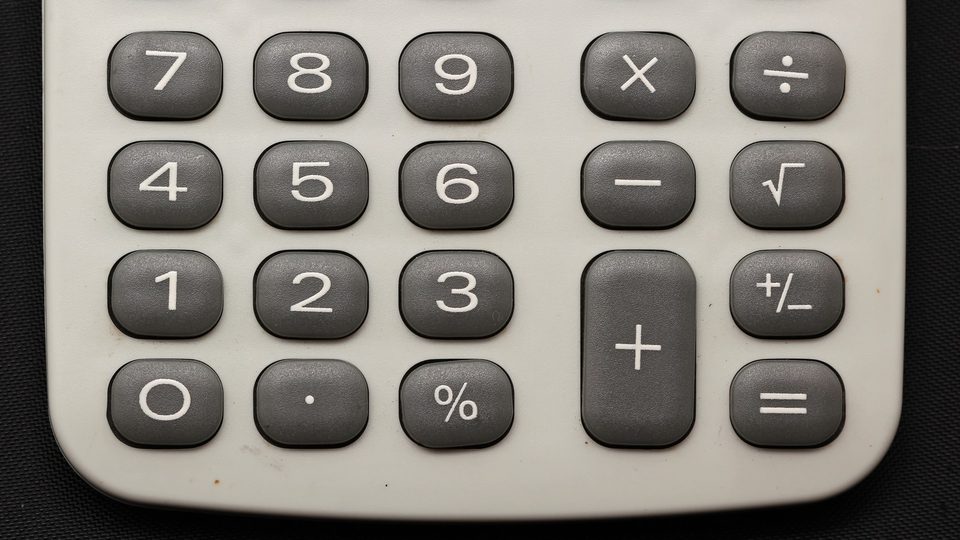 The grey number and function keys of a pocket calculator, seen from above