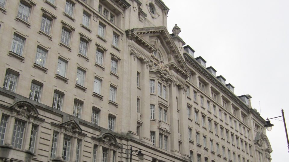 The pale stone facade of St James's Buildings in Manchester, home of the Medical Practitioners Tribunal Service, rising against a grey sky
