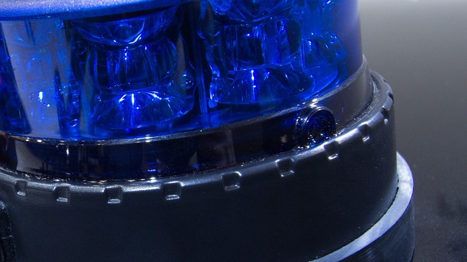 Close view of a deep blue LED police beacon on a black base