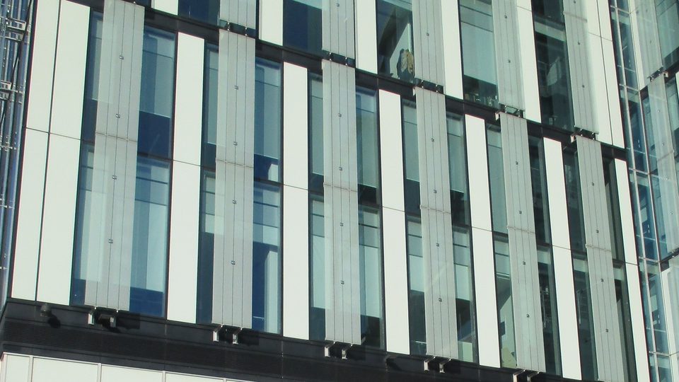 The glass and white-panelled upper facade of 3 Hardman Street, Manchester, the GMC's Manchester office